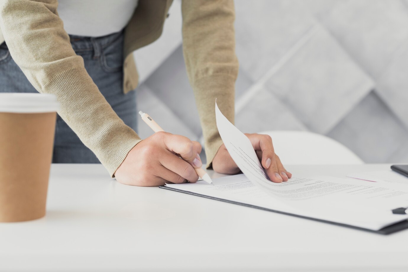 woman-signing-paper-close-up_23-2148327009